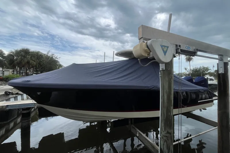  Yacht Photos Pics 2025 Chris-Craft Catalina 28 boat covered and docked under cloudy skies.