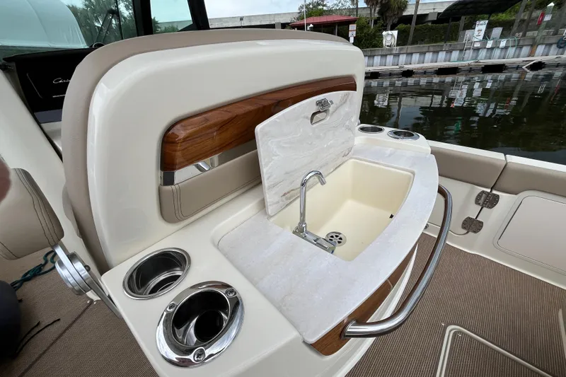  Yacht Photos Pics Luxury sink area on 2025 Chris-Craft Catalina 28 boat, featuring cup holders and elegant design.