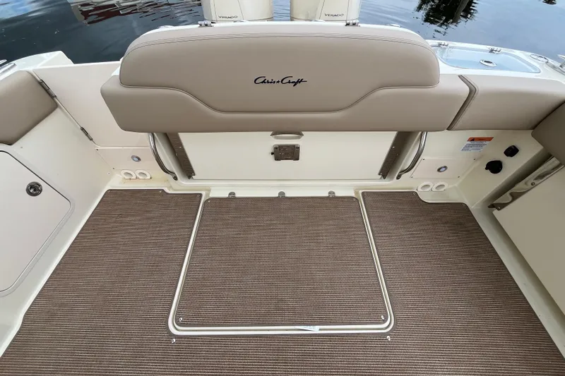  Yacht Photos Pics 2025 Chris-Craft Catalina 28 boat interior with beige seating and carpeted flooring.