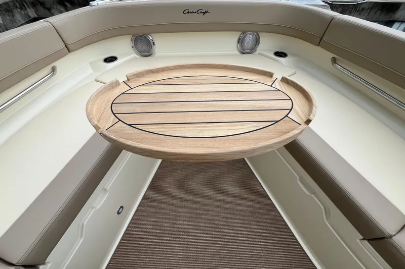  Yacht Photos Pics 2025 Chris-Craft Catalina 28 interior with wooden table and beige seating.