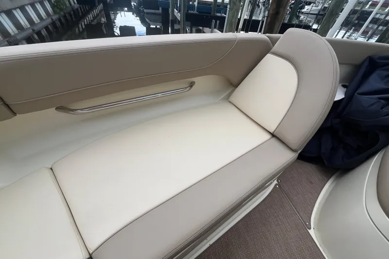  Yacht Photos Pics 2025 Chris-Craft Catalina 28 boat interior with beige seating and stainless steel handrail.