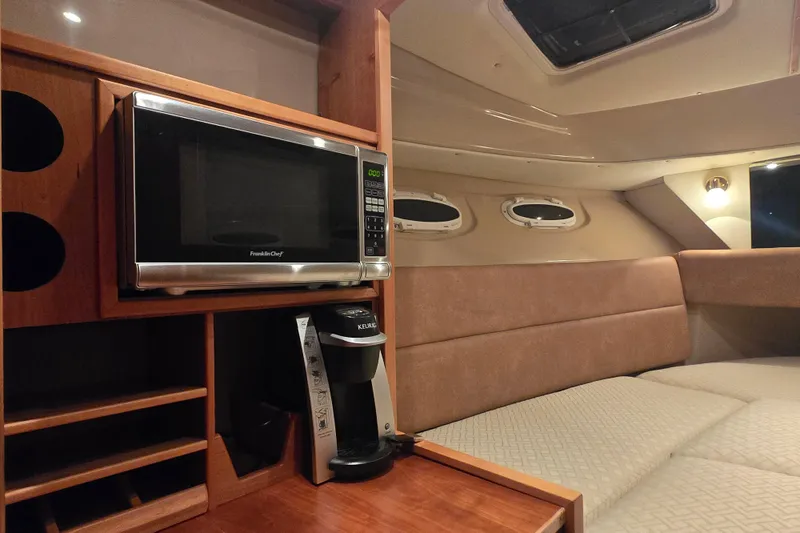  Yacht Photos Pics 2015 Cutwater C28 interior with microwave, coffee maker, and cozy seating area.