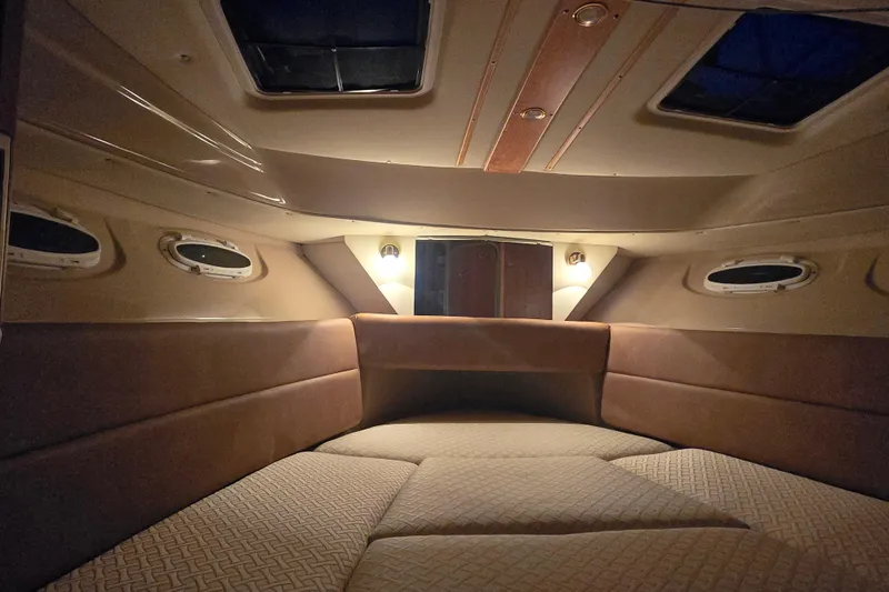  Yacht Photos Pics Interior cabin of a 2015 Cutwater C28 boat, featuring cozy seating and ambient lighting.