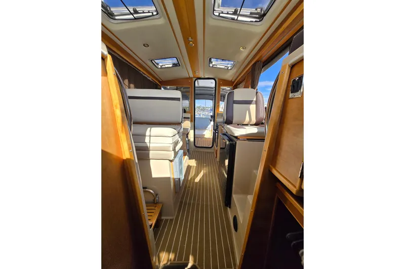  Yacht Photos Pics Interior of a 2015 Cutwater C28 boat, featuring elegant seating and wood finishes.
