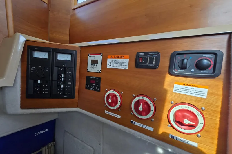  Yacht Photos Pics Control panel of a 2015 Cutwater C28 boat with switches and warning labels.