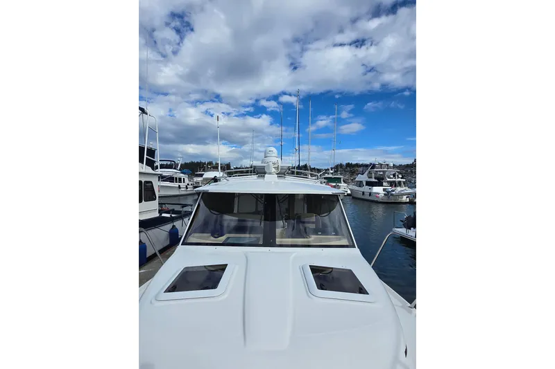  Yacht Photos Pics 2015 Cutwater C28 boat docked in a marina under a partly cloudy sky.