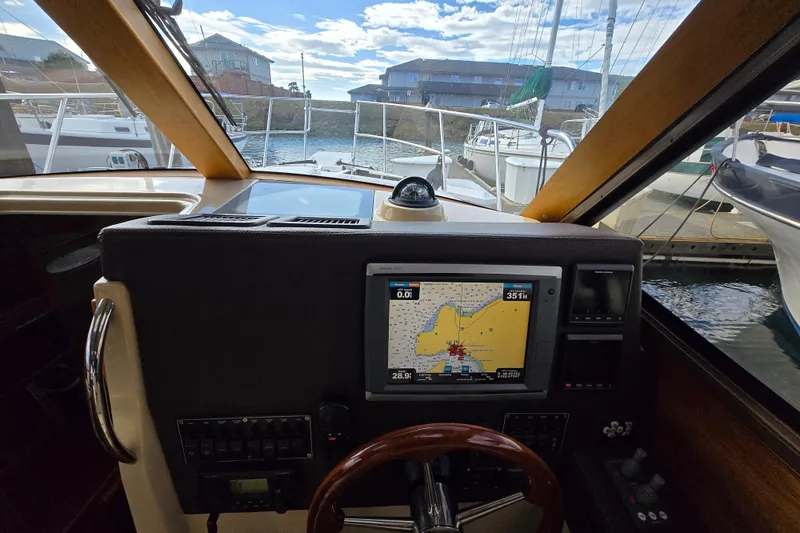  Yacht Photos Pics 2015 Cutwater C28 boat cockpit with navigation system, docked at marina.