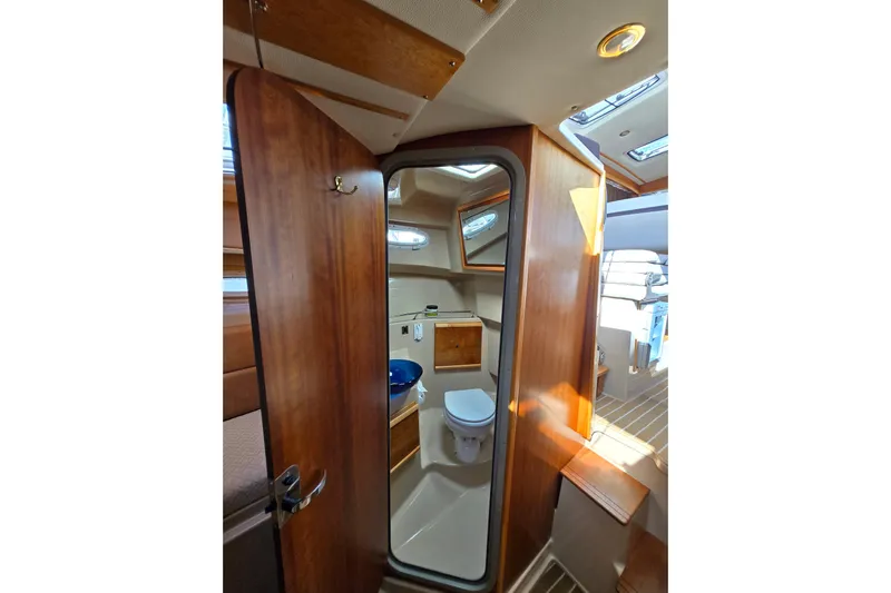  Yacht Photos Pics 2015 Cutwater C28 boat interior with wooden door and compact bathroom.