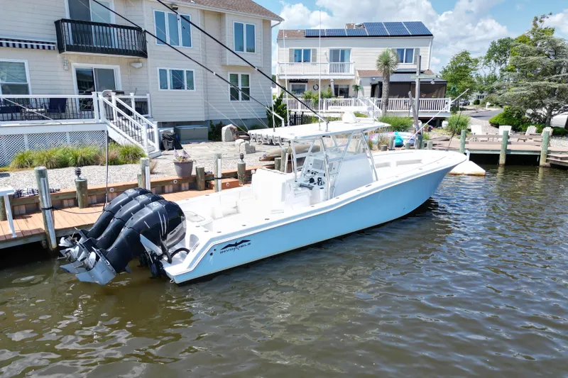  Yacht Photos Pics 2018 Invincible 36 Open Fisherman boat docked near waterfront homes.