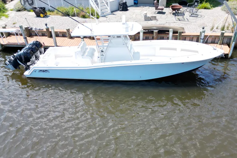 Yacht Photos Pics 2018 Invincible 36 Open Fisherman boat docked by waterfront.