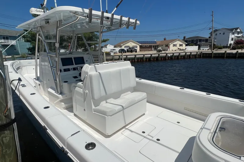 Yacht Photos Pics 2018 Invincible 36 Open Fisherman boat docked by waterfront homes.