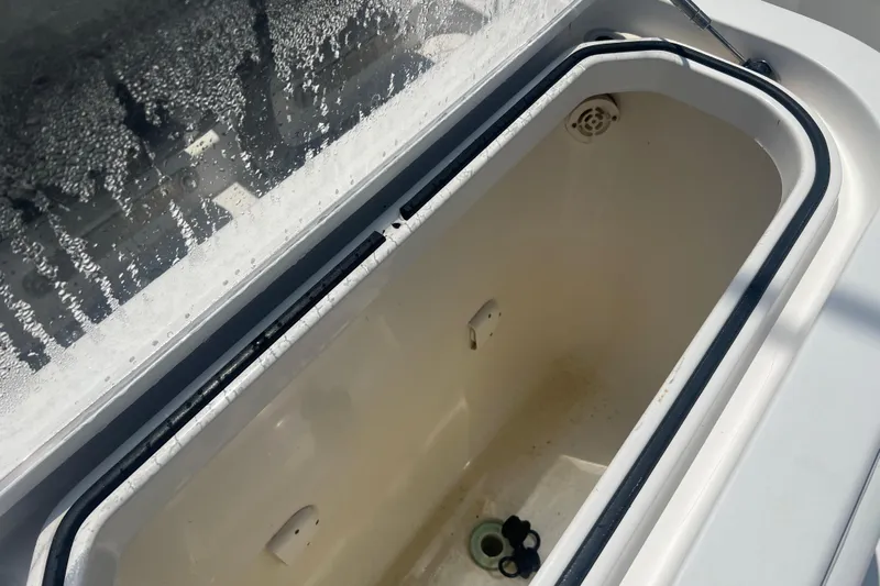  Yacht Photos Pics Open storage compartment on 2018 Invincible 36 Open Fisherman boat, with water droplets on lid.