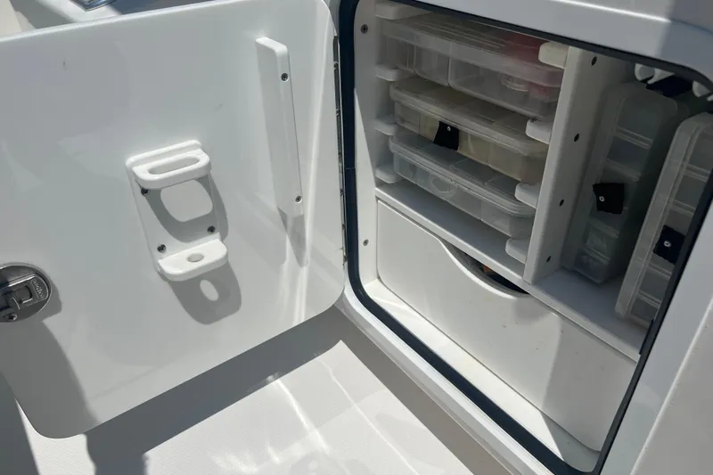  Yacht Photos Pics Storage compartment with tackle boxes on a 2018 Invincible 36 Open Fisherman boat.