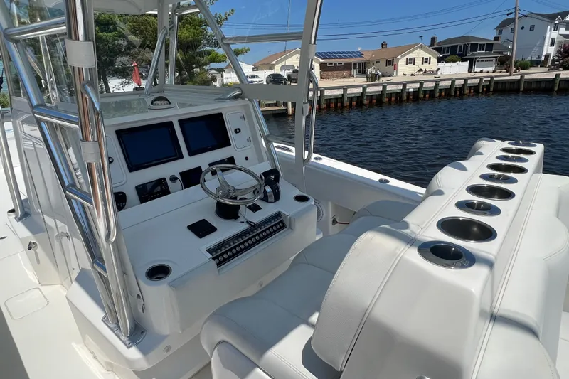  Yacht Photos Pics 2018 Invincible 36 Open Fisherman boat interior with steering console and cup holders.
