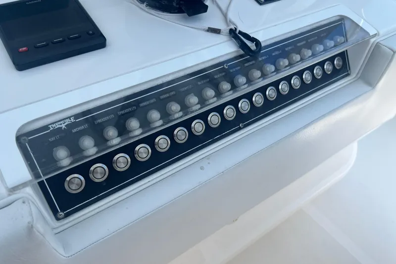  Yacht Photos Pics Control panel of a 2018 Invincible 36 Open Fisherman boat with labeled switches.