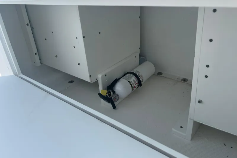  Yacht Photos Pics 2018 Invincible 36 Open Fisherman storage compartment with fire extinguisher.