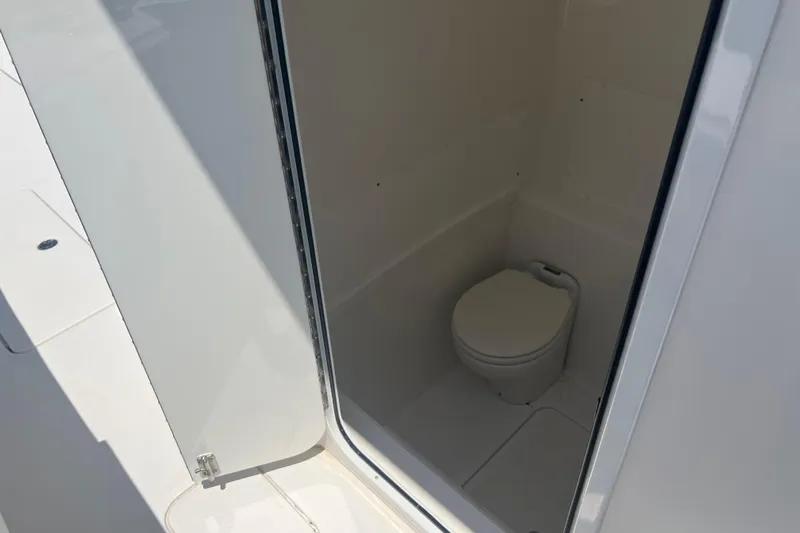  Yacht Photos Pics 2018 Invincible 36 Open Fisherman boat interior with compact marine toilet.
