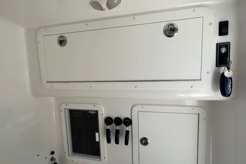  Yacht Photos Pics Control panel and storage compartments on a 2018 Invincible 36 Open Fisherman boat.