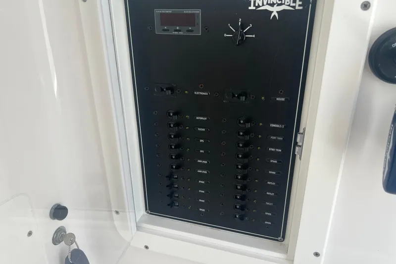  Yacht Photos Pics Control panel of a 2018 Invincible 36 Open Fisherman boat, featuring various switches.
