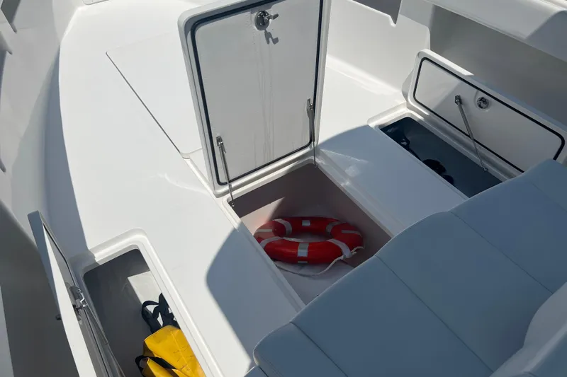  Yacht Photos Pics 2018 Invincible 36 Open Fisherman boat storage compartments with life preserver and gear.