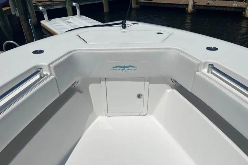  Yacht Photos Pics 2018 Invincible 36 Open Fisherman boat interior, featuring sleek white design and storage compartment.