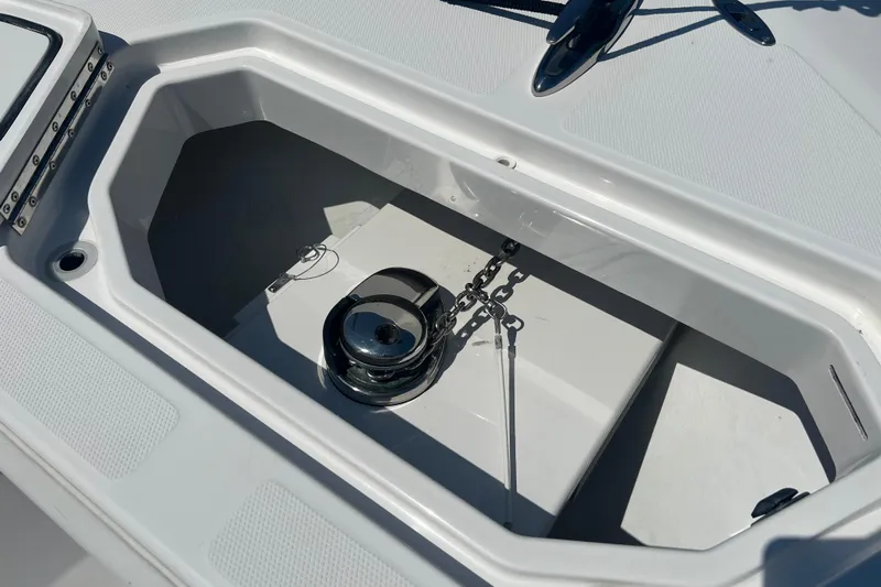 Yacht Photos Pics Anchor compartment of 2018 Invincible 36 Open Fisherman boat, featuring a secure chain and winch.