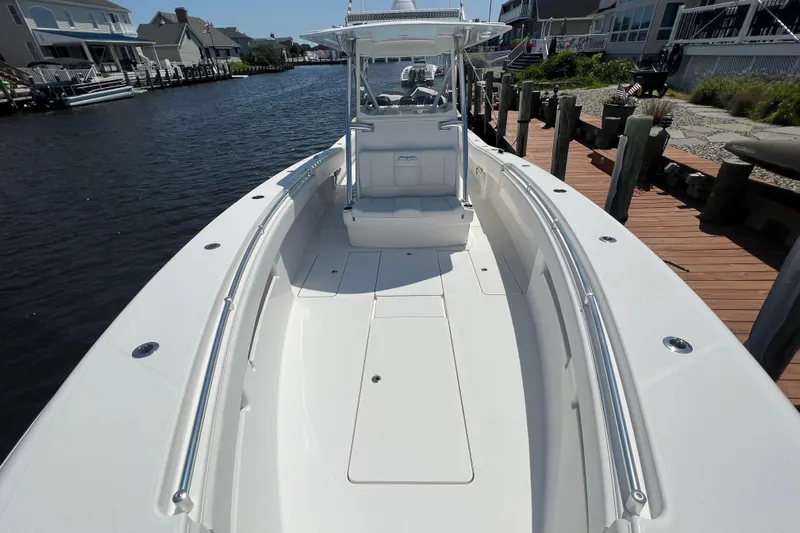  Yacht Photos Pics 2018 Invincible 36 Open Fisherman boat docked by waterfront homes.