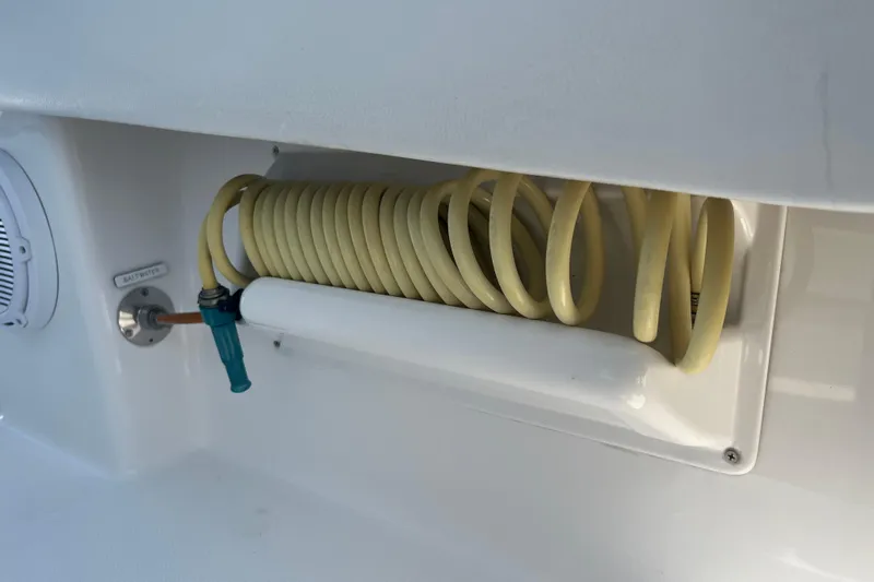  Yacht Photos Pics Coiled hose in 2018 Invincible 36 Open Fisherman boat compartment.