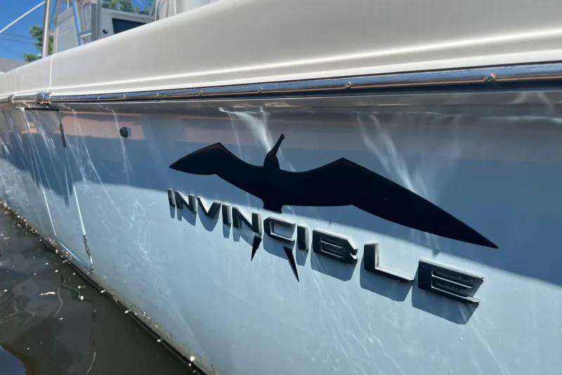  Yacht Photos Pics 2018 Invincible 36 Open Fisherman boat with logo on the side in water.