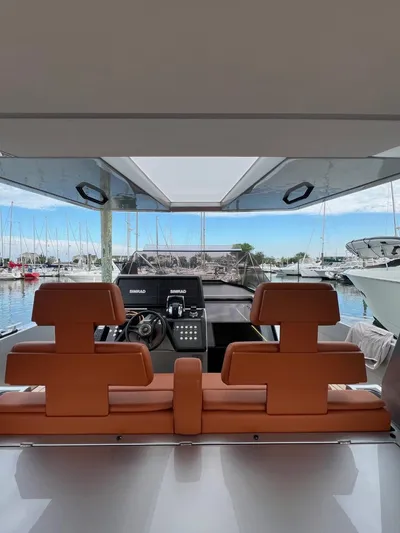 Argento Yacht Photos Pics Interior view of 2023 Wally 48 X yacht with leather seating and marina backdrop.