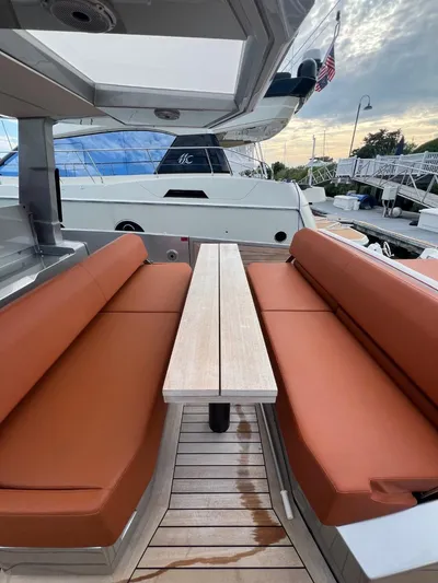 Argento Yacht Photos Pics Luxurious seating area on 2023 Wally 48 X yacht with sleek design and wooden table.
