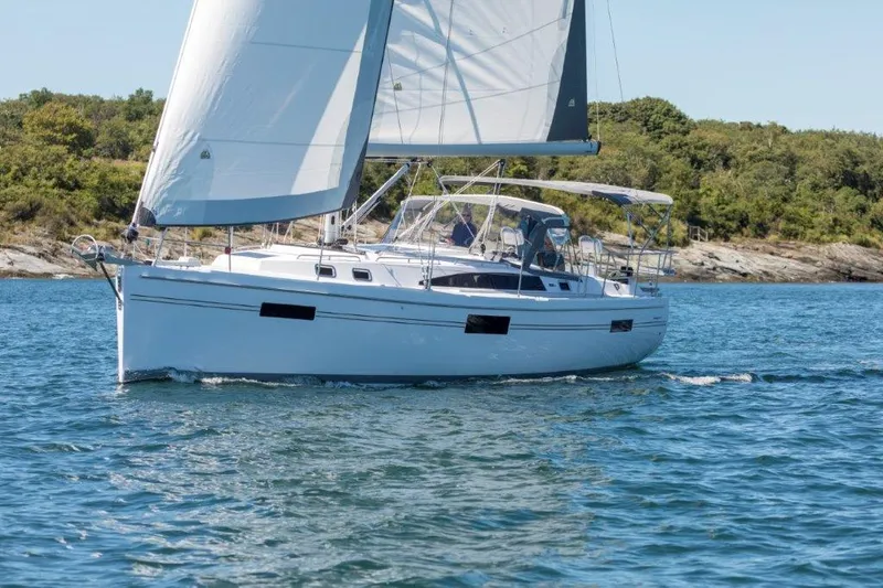  Yacht Photos Pics Sailing yacht Catalina 426, 2026 model, cruising on a sunny day near a forested shoreline.