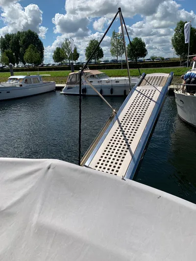 Timeless Yacht Photos Pics Docked Van der Heijden Superior 2000 yacht with gangway, 2009 model, under a cloudy sky.