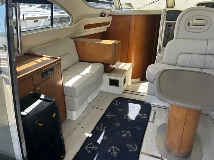  Yacht Photos Pics Interior of 2003 Cranchi Atlantique 40 yacht with beige seating and wooden accents.