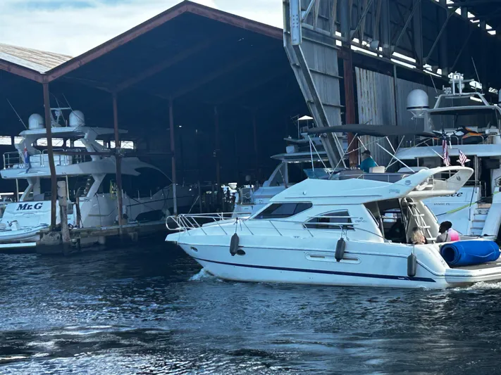  Yacht Photos Pics 2003 Cranchi Atlantique 40 yacht docked in marina with covered boat storage.