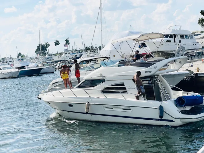  Yacht Photos Pics 2003 Cranchi Atlantique 40 yacht with people enjoying a sunny day at the marina.
