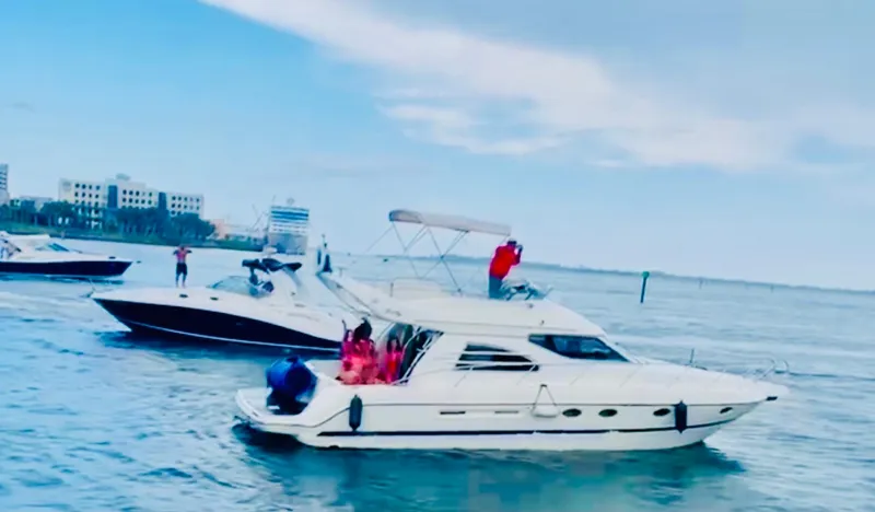  Yacht Photos Pics 2003 Cranchi Atlantique 40 yacht cruising on a sunny day with people onboard.