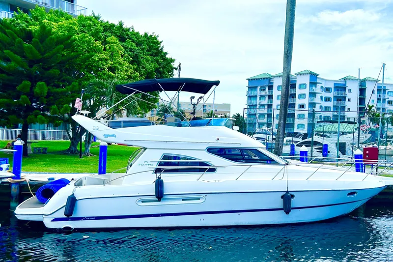  Yacht Photos Pics 2003 Cranchi Atlantique 40 yacht docked near waterfront buildings.