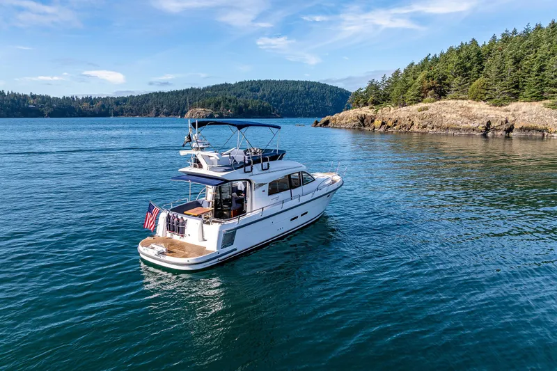 Endeavour Yacht Photos Pics Nimbus 405 Flybridge 2023 yacht cruising in scenic coastal waters.