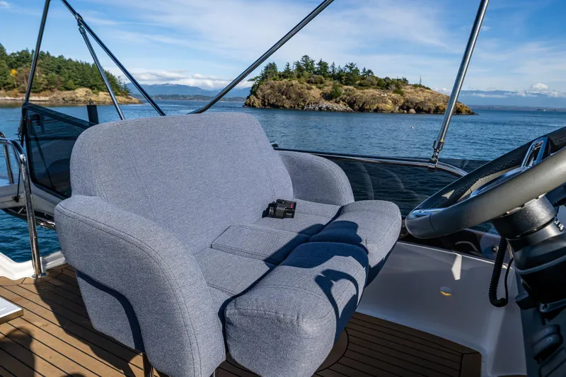 Endeavour Yacht Photos Pics Luxurious 2023 Nimbus 405 Flybridge yacht with plush seating and scenic ocean view.