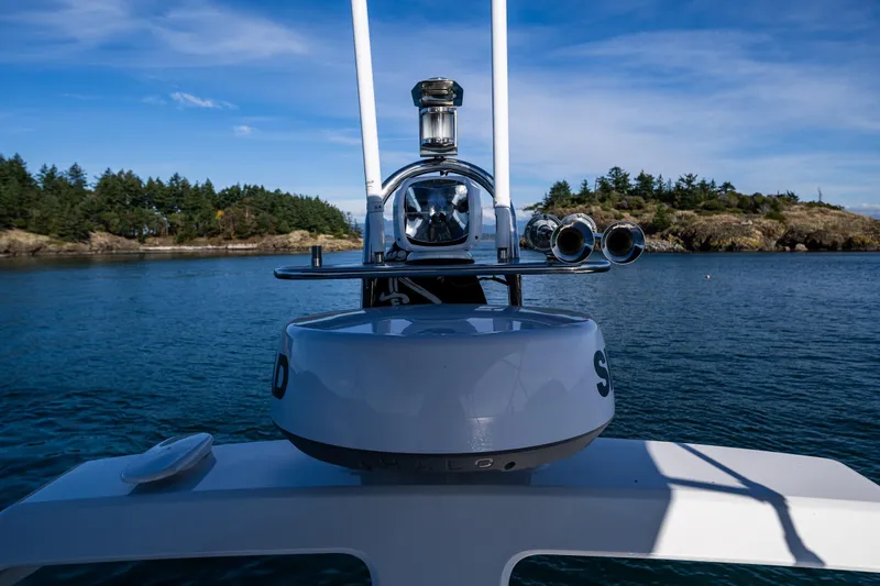 Endeavour Yacht Photos Pics Nimbus 405 Flybridge 2023 on serene water with scenic island backdrop.