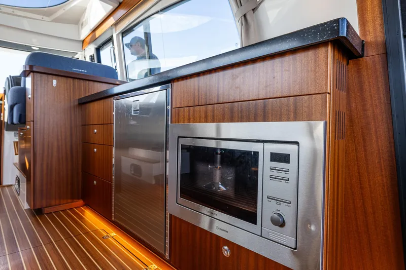 Endeavour Yacht Photos Pics Luxurious interior of 2023 Nimbus 405 Flybridge yacht with modern kitchen appliances.
