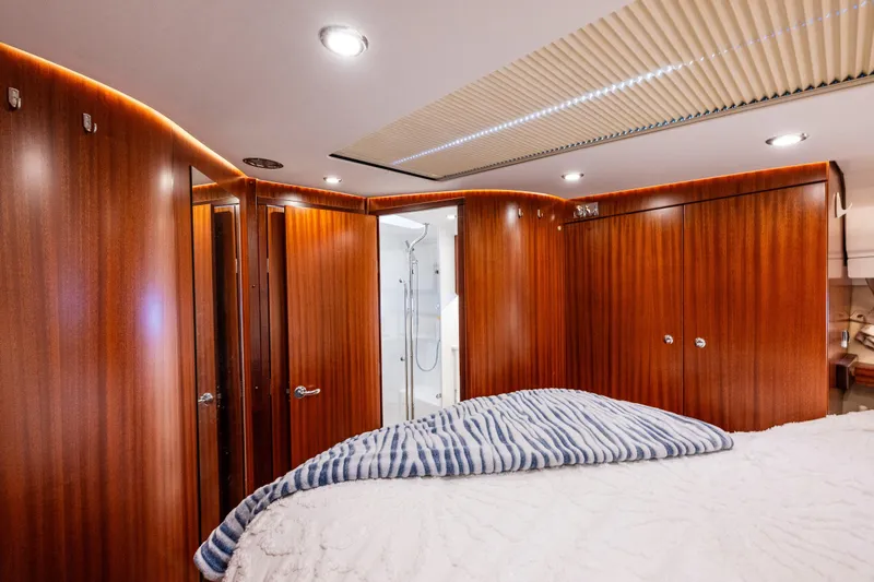 Endeavour Yacht Photos Pics Luxurious interior of 2023 Nimbus 405 Flybridge yacht with wood paneling and modern lighting.