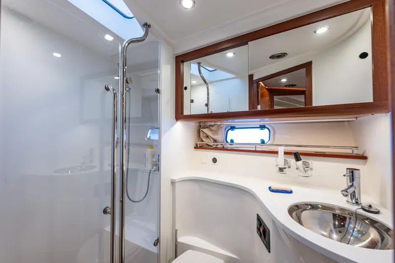 Endeavour Yacht Photos Pics Luxurious bathroom in 2023 Nimbus 405 Flybridge yacht with modern fixtures and elegant design.