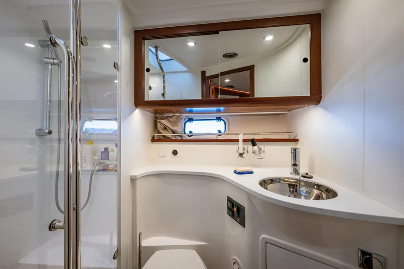 Endeavour Yacht Photos Pics Luxurious bathroom in 2023 Nimbus 405 Flybridge yacht with modern fixtures and elegant design.