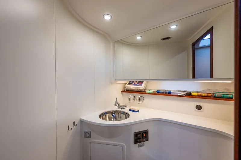 Endeavour Yacht Photos Pics Luxurious bathroom interior of 2023 Nimbus 405 Flybridge yacht, featuring modern sink and mirror.