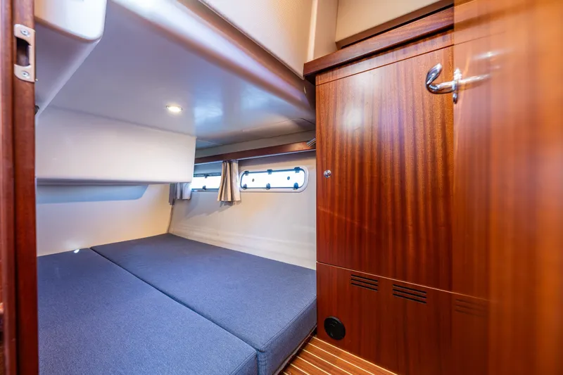 Endeavour Yacht Photos Pics Luxurious cabin interior of 2023 Nimbus 405 Flybridge yacht with wooden finishes.