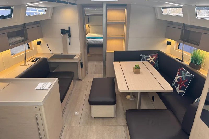 Yacht Photos Pics 2024 Beneteau Oceanis 46.1 interior with modern dining area and cozy seating.