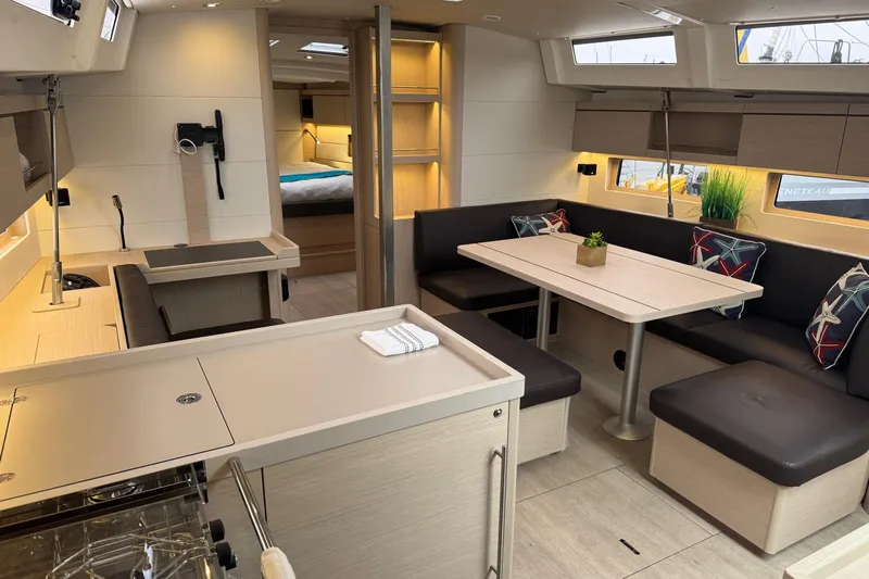  Yacht Photos Pics 2024 Beneteau Oceanis 46.1 interior with modern kitchen and cozy dining area.
