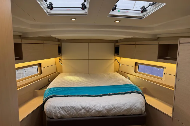  Yacht Photos Pics Luxurious interior cabin of 2024 Beneteau Oceanis 46.1 yacht with skylights and modern design.